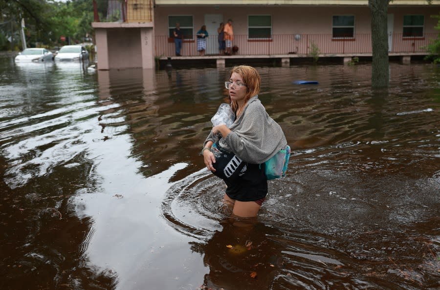Makatla Ritchter wades through flood waters after having to evacuate her home when the flood waters from Hurricane Idalia inundated it on August 30, 2023 in Tarpon Springs, Florida. Hurricane Idalia is hitting the Big Bend area on the Gulf Coast of Florida. (Photo by Joe Raedle/Getty Images)