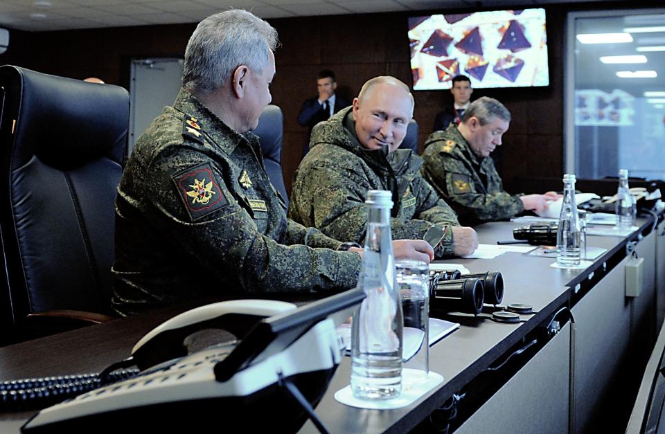 Russian president Vladimir Putin (C) smiles while inspecting the Vostok-2022 military exercises. (SPUTNIK/AFP via Getty Images)