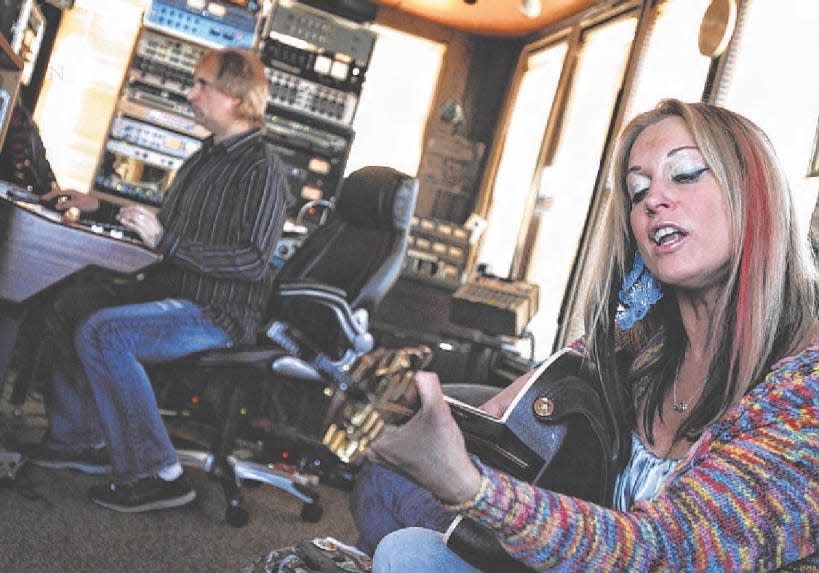 Singer-songwriter Lisa Bouchelle rehearses at Sound Spa Recording and Production Studio, where the Sandy relief song, “Restore the Show” was recorded. In the back is Steve DeAcutis, owner of the studio.