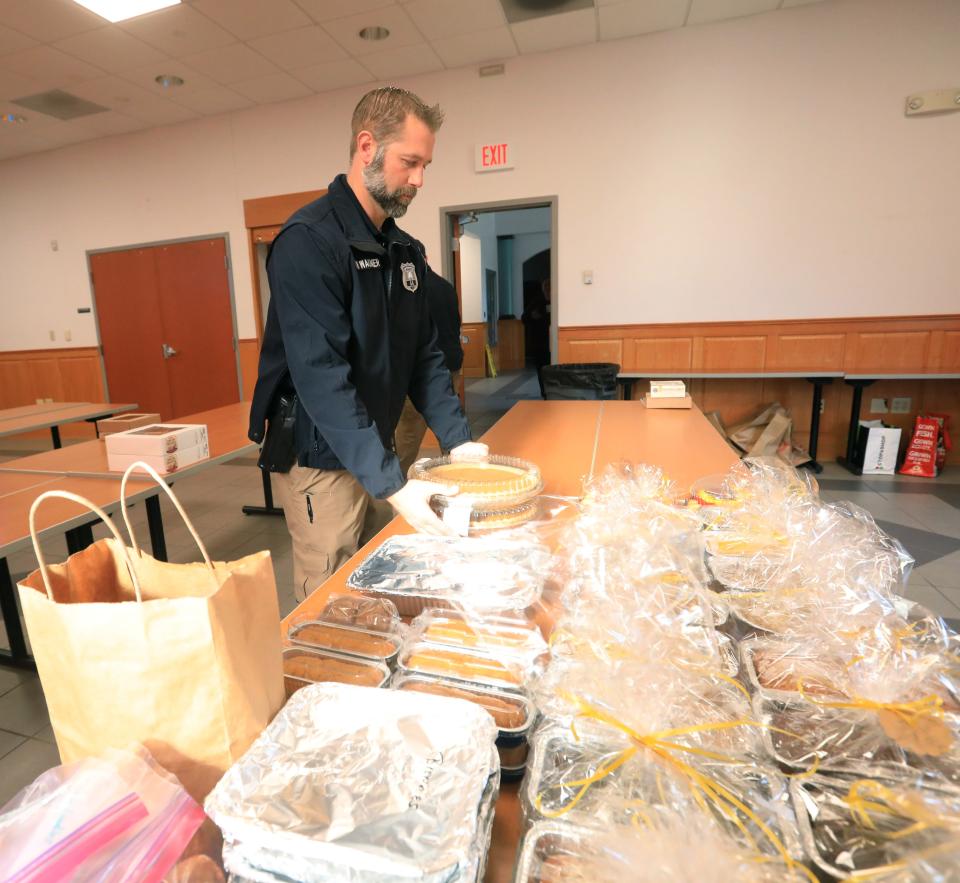 City of Poughkeepsie Police officer Kevin VanWagner sorts pies donated by community members for the police department's Thanksgiving dessert drive at the City of Poughkeepsie Public Safety Building on November 22, 2022.