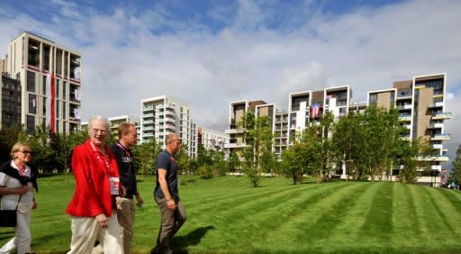 Queen Margrethe II of Denmark (2L) walks through the Olympic athletes village during a short tour of the site in Stratford, east London on August 8, 2012. London may have basked in the euphoria of a successful Olympics in 2012 but now that the party is over, local people are wondering if its legacy can improve the deprived area which hosted the Games