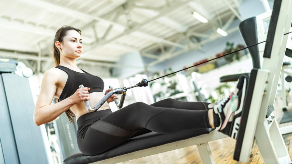 A woman performing a seated cable row