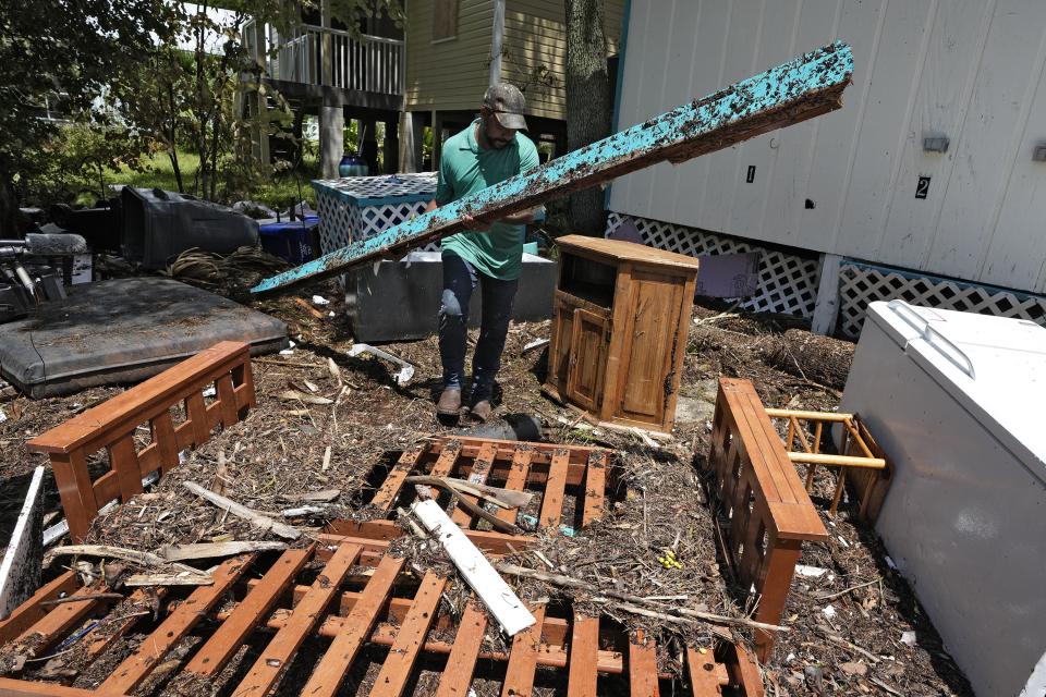 Jorge Larancuent cleans up debris from Hurricane Idalia at the Faraway Inn Thursday, Aug. 31, 2023, in Cedar Key, Fla. Idalia made landfall early Wednesday morning along Florida's panhandle. (AP Photo/Chris O'Meara)