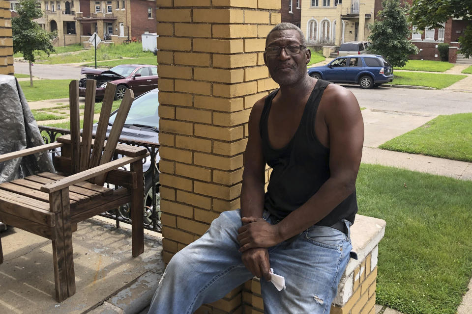 Roofer Anthony Brookins poses for a photo as on the porch of a friend's home on Detroit's westside, Friday, July 28, 2023. That home and his own home have no central air conditioning. As climate change fans hotter and longer heat waves, breaking record temperatures across the U.S. and leaving dozens dead, the poorest Americans suffer the hottest days with the fewest defenses. Air conditioning, once a luxury, is now a matter of survival. (AP Photo/Corey Williams)