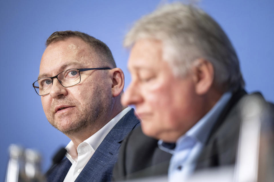 Frank Werneke, left, chairman of the Ver.di union, and Martin Burkert, chairman of the EVG union, give a joint press conference, in Berlin, Thursday, March 23, 2023. German unions are calling on thousands of workers across the country's transport system to stage a one-day strike on Monday that is expected to bring widespread disruption to planes, trains and local transit. (Monika Skolimowska/dpa via AP)