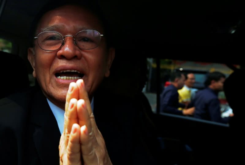 Cambodian opposition leader Kem Sokha greets as he leaves the Municipal Court of Phnom Penh