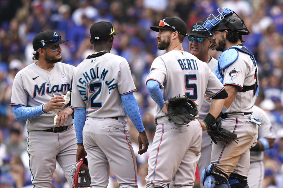 Miami Marlins manager Don Mattingly, second from right, talks to his team during the fifth inning of a baseball game against the Chicago Cubs in Chicago, Sunday, June 20, 2021. (AP Photo/Nam Y. Huh)