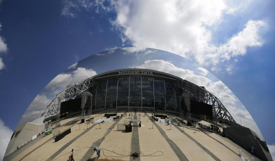 AT&T Stadium, home of the Dallas Cowboys, is reflected in an art piece by Anish Kapoor titled "Sky Mirror", located on the east plaza of the venue, Friday, Oct. 11, 2013, in Arlington, Texas. The concave disc covered in polished steel had temporary homes in New York, London and Sydney before getting a permanent spot in a black granite fountain outside the huge sliding glass doors on the east side of the stadium. (AP Photo/Tony Gutierrez)