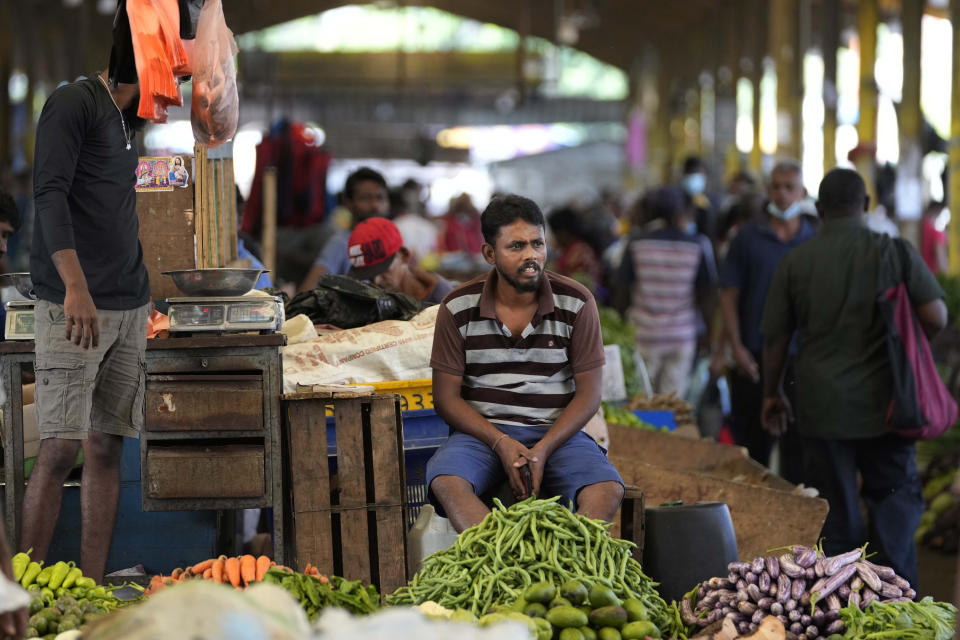 FILE - A vender waits for customers at a vegetable market place in Colombo, Sri Lanka, Friday, June 10, 2022. Some 1.6 billion people in 94 countries face at least one dimension of the crisis in food, energy and financial systems, according to a report last month by the Global Crisis Response Group of the United Nations Secretary-General. (AP Photo/Eranga Jayawardena, File)