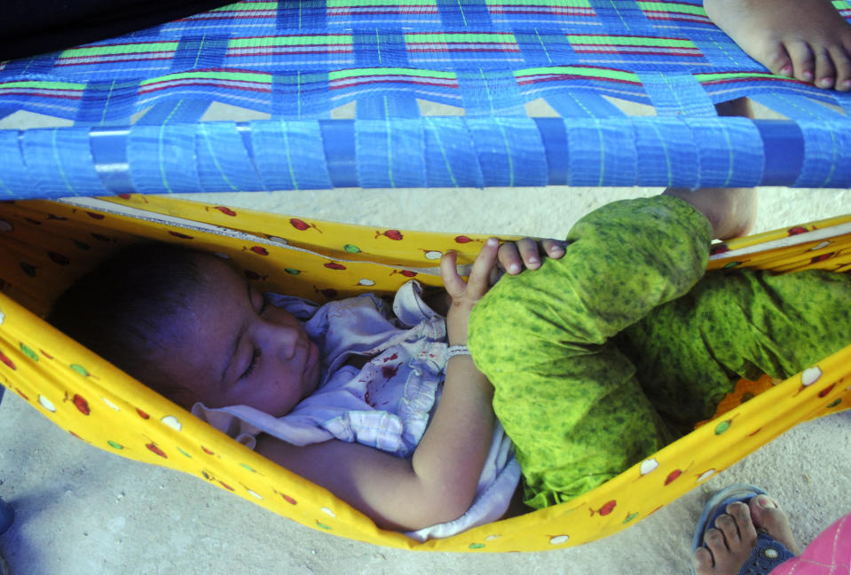 A young flood victim sleeps after a heavy rain at a relief camp in Hyderabad, Pakistan, Tuesday, Sept. 6, 2022. In flood-stricken Pakistan where an unprecedented monsoon season has already killed hundreds of people, the rains are now threatening an ancient archeological site dating back 4,500 years, the site's chief official said Tuesday. (AP Photo/Pervez Masih)