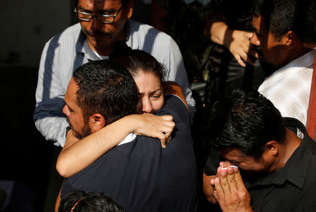 Family members attend the funeral of German Torres, 38, a victim of the earthquake that struck the southern coast of Mexico late on Thursday, in Juchitan, Mexico, September 9, 2017. REUTERS/Carlos Jasso