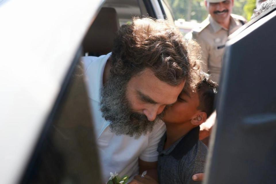 A young boy rushes to kiss Rahul Gandhi in Wayanad as the leader visited his constituency for a regular trip in March (Supplied)