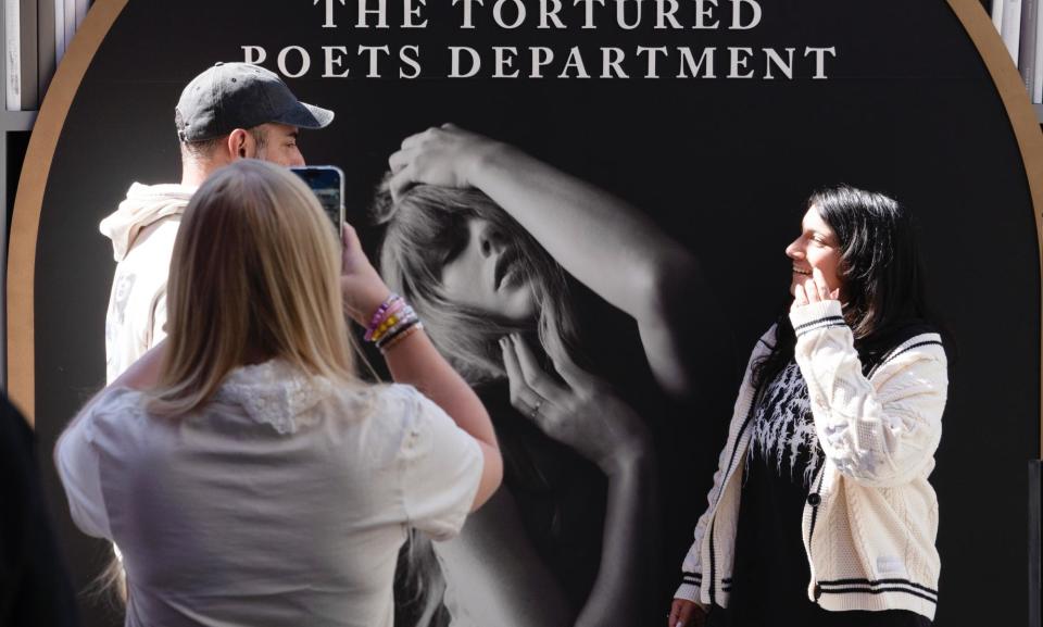 <span>Taylor Swift fans take selfies at a pop-up for the singer’s new album The Tortured Poets Department in Los Angeles</span><span>Photograph: Richard Vogel/AP</span>