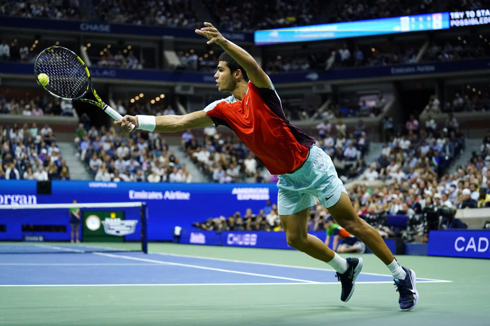 Carlos Alcaraz, of Spain, returns a shot to Frances Tiafoe, of the United States, during the semifinals of the U.S. Open tennis championships, Friday, Sept. 9, 2022, in New York. (AP Photo/Matt Rourke)