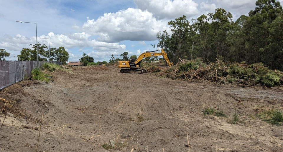 A bulldozer at the site west of the Queen Elizabeth II Jubilee Hospital which has been cleared.