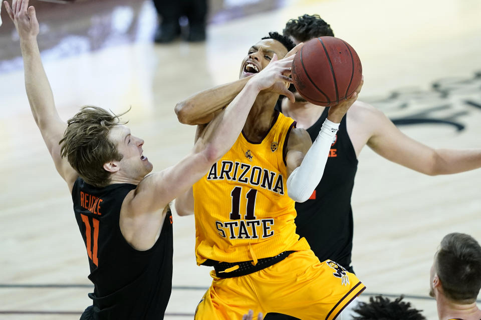 Arizona State guard Alonzo Verge Jr. (11) is fouled by Oregon State guard Zach Reichle (11) during the second half of an NCAA college basketball game, Sunday, Feb. 14, 2021, in Tempe, Ariz.(AP Photo/Matt York)