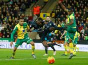 Arsenal's striker Joel Campbell (2nd L) vies with Norwich City's defender Martin Olsson (L) and Norwich City's defender Sebastien Bassong during the English Premier League football match at Carrow Road in Norwich, England on November 29, 2015