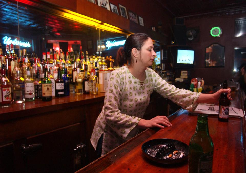 Bartender Jessica Schlitz serves some regulars at the Uptowner, 1032 E. Center St., in this 2004 photo. The Riverwest tavern opened in 1884.