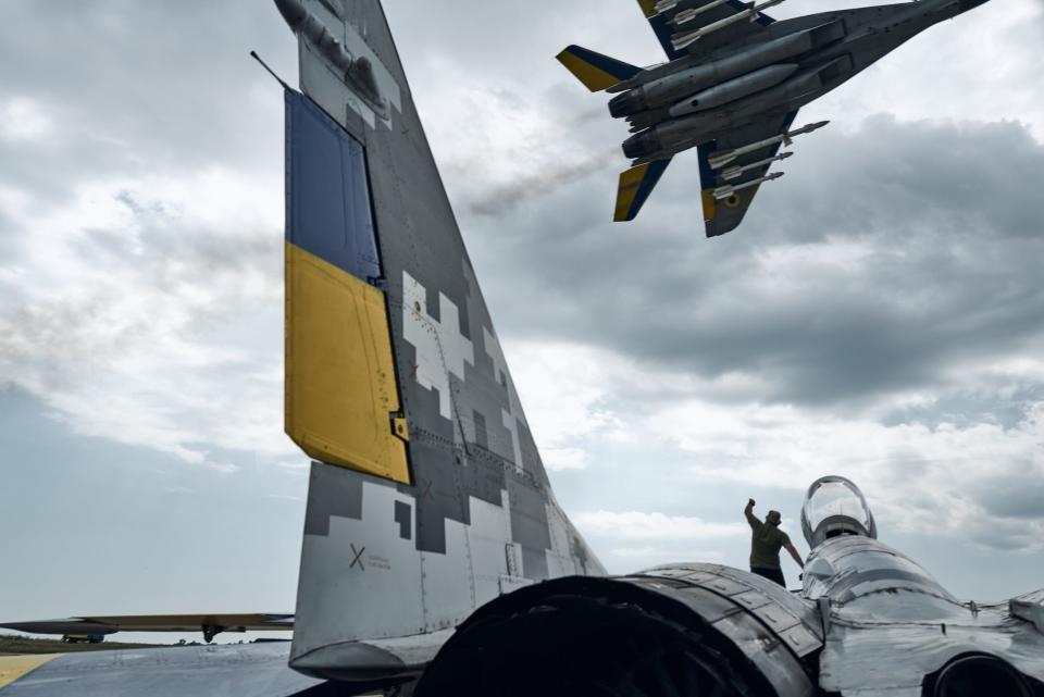 A Ukrainian MIG-29 pilot flies over the runway and salutes the technicians who are preparing another aircraft for combat sortie on August 2, 2023 in eastern Ukraine. - Copyright: Libkos/Getty Images