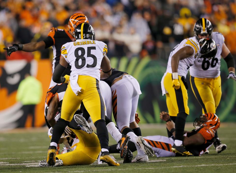 Pittsburgh Steelers wide receiver JuJu Smith-Schuster (19) stands over a motionless Cincinnati Bengals outside linebacker Vontaze Burfict (55) after making hard helmet to helmet contact on a block in the fourth quarter of the NFL Week 13 game between the Cincinnati Bengals and the Pittsburgh Steelers at Paul Brown Stadium in downtown Cincinnati on Tuesday, Dec. 5, 2017. The Bengals gave up a 17-3 halftime lead to lose 23-20 on a last-second field goal. 