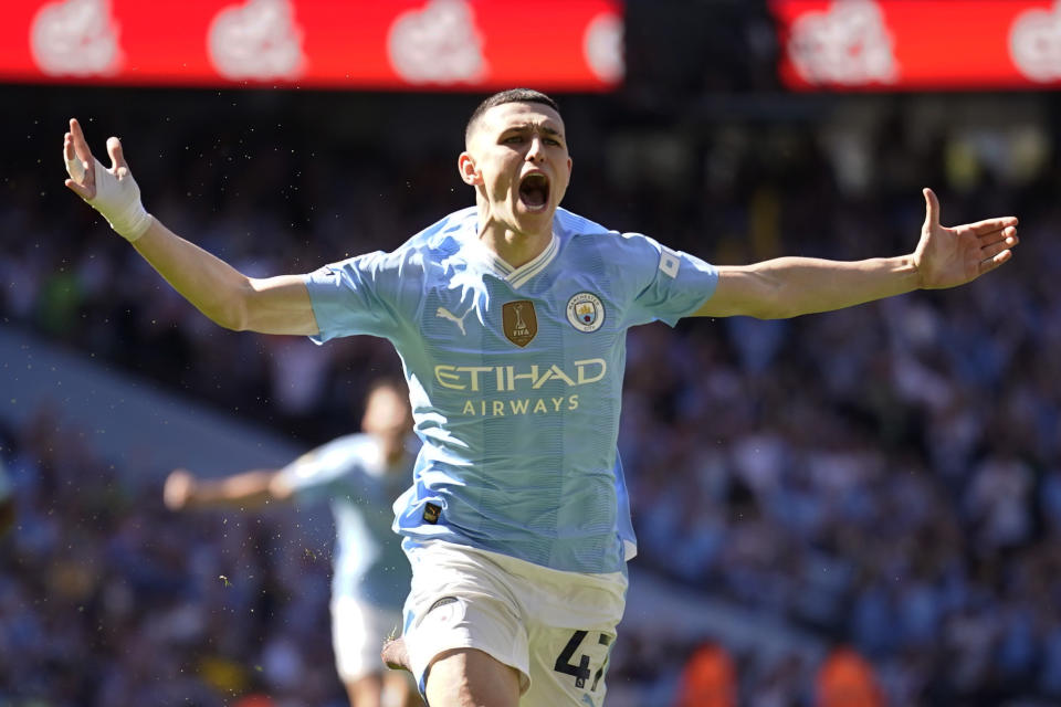 Manchester City's Phil Foden celebrates after scoring his side's opening goal during the English Premier League soccer match between Manchester City and West Ham United at the Etihad Stadium in Manchester, England, Sunday, May 19, 2024. (AP Photo/Dave Thompson)