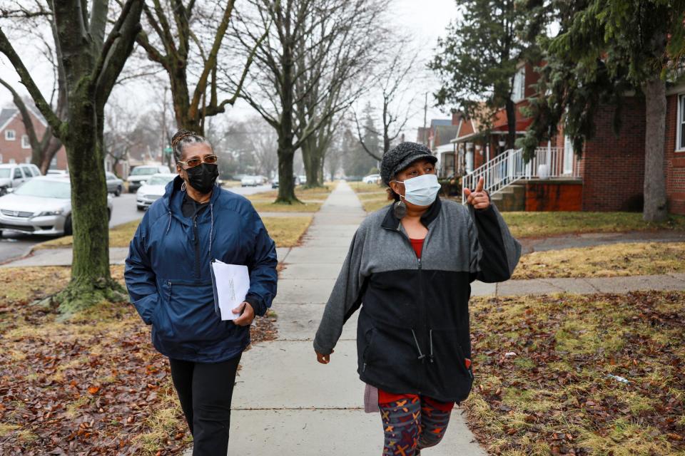 Volunteers Loretta Powell, 60, of Detroit, left, and Yvonne Willis, of Detroit, from Eastside Community Network (ECN), go door to door to let people know they are in danger of losing their homes to property tax foreclosure and hand out packets of information to save their homes on March 19, 2022. Property tax foreclosures are resuming in Wayne County after March 31.