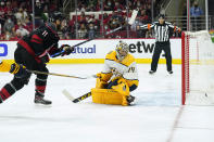 Carolina Hurricanes center Jordan Staal (11) scores against Nashville Predators goaltender Juuse Saros (74) during overtime in Game 5 of an NHL hockey Stanley Cup first-round playoff series in Raleigh, N.C., Tuesday, May 25, 2021. (AP Photo/Gerry Broome)