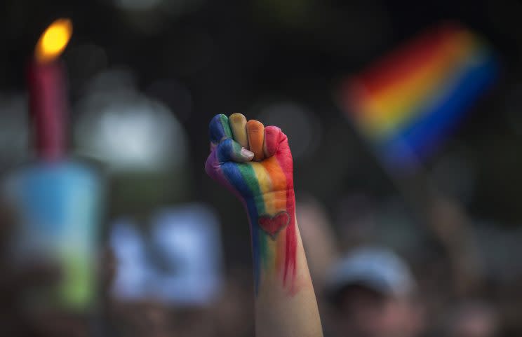 A defiant fist is raised at a vigil in Los Angeles, for the victims of the Orlando nightclub shooting. (Photo: David McNew/Getty Images)