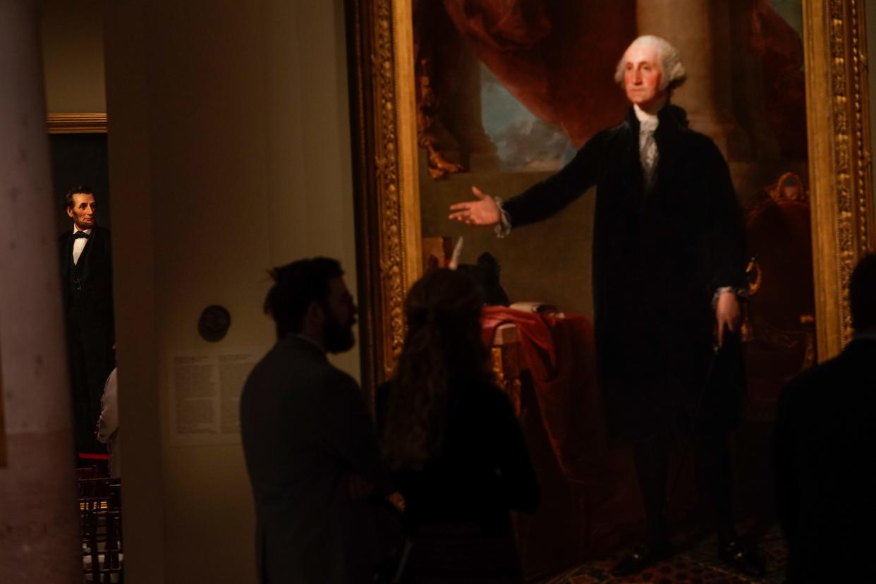 The gesture of Gilbert Stuart’s Lansdowne portrait of George Washington—a highlight of the Portrait Gallery’s permanent collection, right, seemingly welcomes visitors to the the life-size painting of President Abraham Lincoln by artist W.F.K. Travers created in 1865 as the Lincoln portrait is unveiled at the National Portrait Gallery in Washington, D.C. on Friday, February 10, 2023.