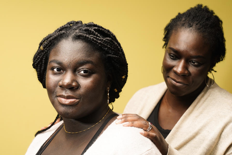 Ebele Azikiwe, 12, poses for a photo with her mother, Rume Joy Azikiwe-Oyeyemi, in Cherry Hill, N.J., Wednesday, March 24, 2021. Ebele testified in October at state Assembly hearing, lending her support to legislation requiring New Jersey's school districts to add diversity to curriculums. Democratic Gov. Phil Murphy signed the bill into law. (AP Photo/Matt Rourke)