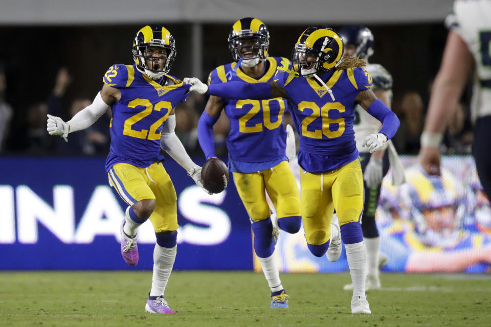 Los Angeles Rams cornerback Troy Hill, left, celebrates after his interception with Marqui Christian, right, and Jalen Ramsey during the second half of an NFL football game against the Seattle Seahawks Sunday, Dec. 8, 2019, in Los Angeles. (AP Photo/Marcio Jose Sanchez)