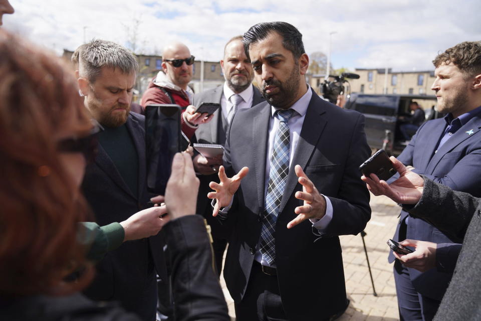 Scotland's First Minister Humza Yousaf speaks to the media during a visit to the Hillcrest Homes housing development, to make an announcement about investment in affordable housing, in Dundee, Scotland, Friday April 26, 2024. Scotland’s first minister, Humza Yousaf, has resigned rather than face a no-confidence vote just days after he torpedoed a coalition with the Green Party by ditching a target for fighting climate change. (Andrew Milligan/PA via AP)