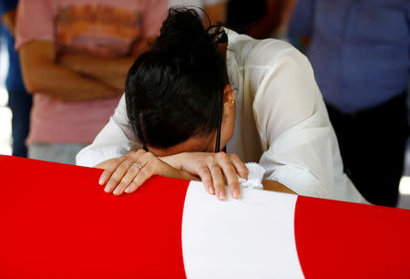 FILE PHOTO: A relative of Gulsen Bahadir, a victim of the attack on Ataturk airport, mourns at her flag-draped coffin in Istanbul, Turkey, June 29, 2016. REUTERS/Osman Orsal/File Photo