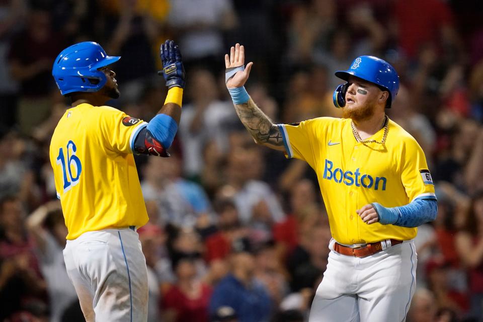 Alex Verdugo, right, celebrates with Boston Red Sox teammate Franchy Cordero (16) after scoring on an RBI-single by Christian Vazquez in the sixth inning of Monday night's game against the Guardians. The Red Sox won 3-1. [Charles Krupa/Associated Press]