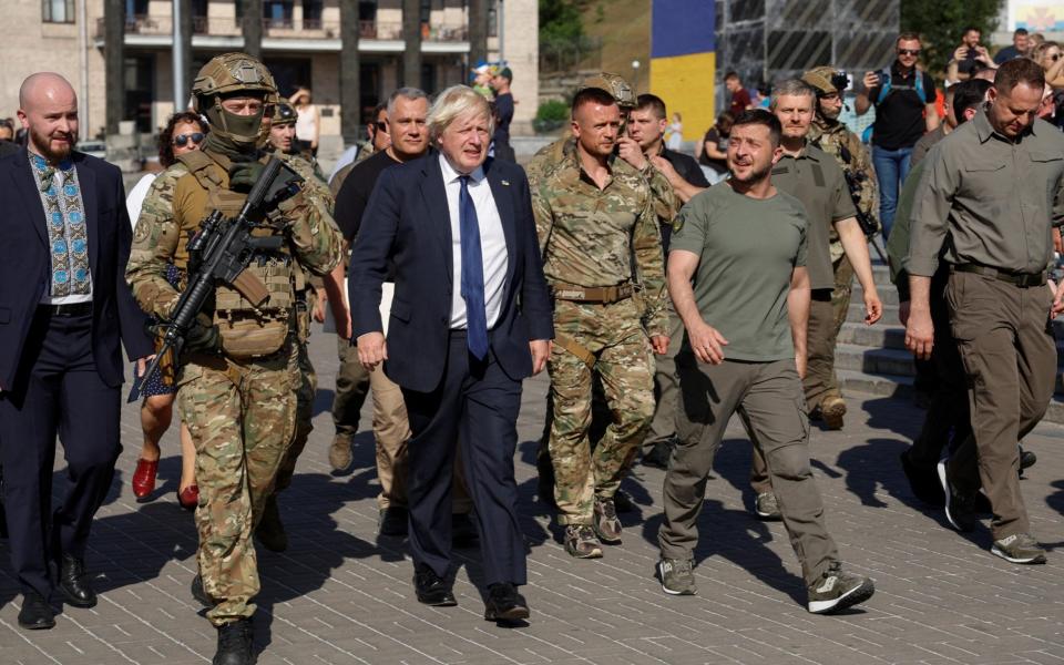 British Prime Minister Boris Johnson and Ukrainian President Volodymyr Zelensky walk in Kyiv's Independence Square. - Reuters