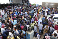 Thousands of people leaving for their native places to celebrate Eid-al-Fitr crowd the Mawa ferry terminal ignoring risks of coronavirus infection in Munshiganj, Bangladesh, Thursday, May 13, 2021. (AP Photo/Mahmud Hossain Opu)