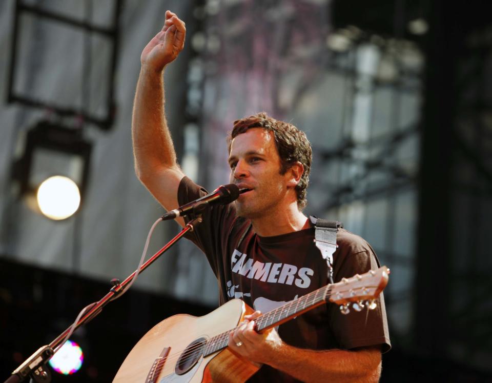 FILE - This Sept. 22, 2012 file photo shows Jack Johnson performing during the Farm Aid 2012 concert at Hersheypark Stadium in Hershey, Pa. Johnson has agreed to take the Saturday night headlining slot at the Bonnaroo Music & Arts Festival after Mumford & Sons were forced to cancel due to bassist Ted Dwane's illness. Festival officials announced the move Friday morning. The "Upside Down" singer last headlined at Bonnaroo in 2008. (AP Photo/Jacqueline Larma, file)