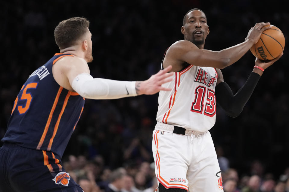 Miami Heat center Bam Adebayo (13) looks to move the ball around New York Knicks center Isaiah Hartenstein in the first half of an NBA basketball game, Wednesday, March 29, 2023, at Madison Square Garden in New York. (AP Photo/Mary Altaffer)