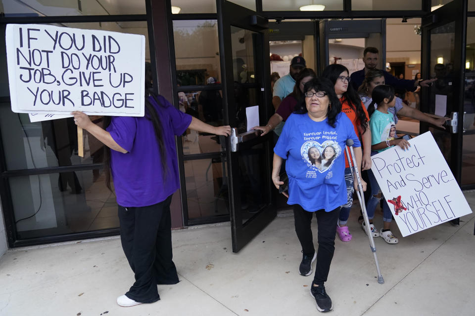 FILE - Family, parents and friends file out of a meeting where Uvalde School District Police Chief Pete Arredondo was dismissed by the Board of Trustees of the Uvalde Consolidated Independent School District, Wednesday, Aug. 24, 2022, in Uvalde, Texas. Four months after the Robb Elementary School shooting, the Uvalde school district on Friday, Oct. 7 pulled its entire embattled campus police force off the job following a wave of new outrage over the hiring of a former Texas state trooper who was part of the hesitant law enforcement response as a gunman killed 19 children and two teachers. (AP Photo/Eric Gay, File)