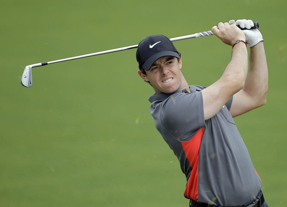 Rory McIlroy grimaces as he hits from the fairway to 16th green during the pro-am of the Wells Fargo Championship golf tournament at Quail Hollow Club in Charlotte, N.C., Wednesday, April 30, 2014. (AP Photo/Bob Leverone)