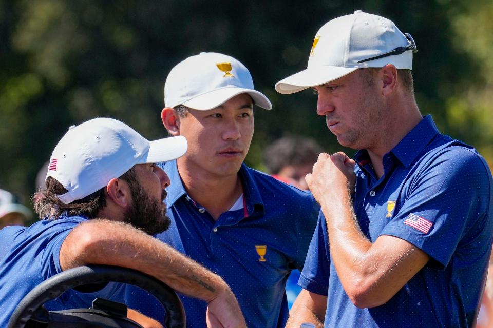 Team USA golfer Max Homa (left), golfer Collin Morikawa (center), and golfer Justin Thomas (right) talk on the eighth tee during the four-ball match play of the Presidents Cup golf tournament at Quail Hollow Club. Mandatory Credit: Jim Dedmon-USA TODAY Sports