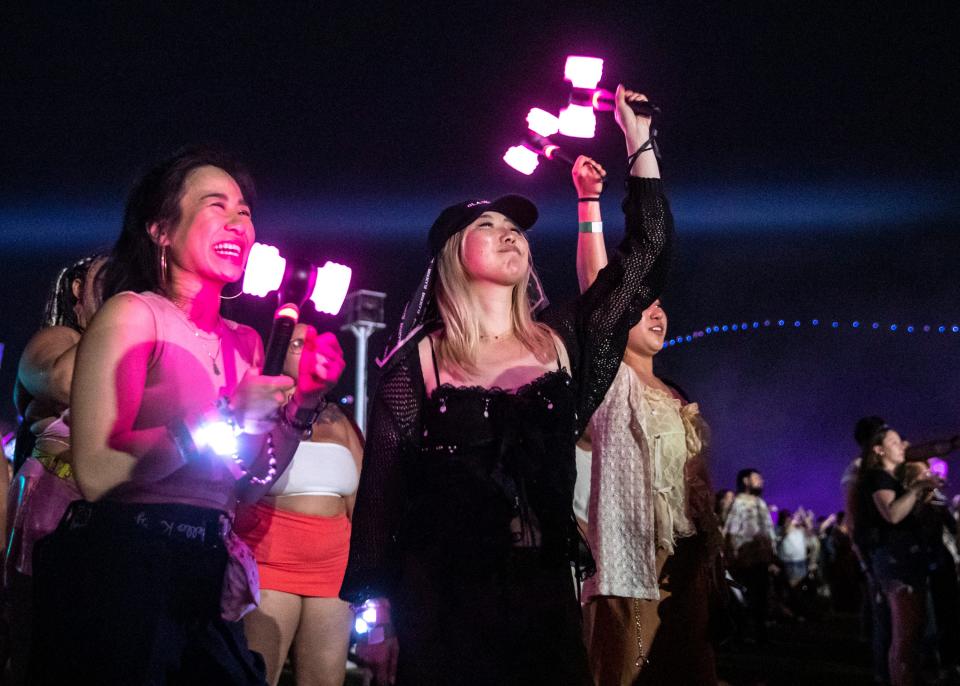 Ashleigh Tran, left, and Annie Choi of Los Angeles dance and sing along as BLACKPINK performs Saturday on the Coachella Stage during the Coachella Valley Music and Arts Festival at the Empire Polo Club in Indio.