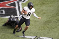 Army quarterback Christian Parrish, right, runs past Cincinnati defensive lineman Curtis Brooks during the first half of an NCAA college football game Saturday, Sept. 26, 2020, in Cincinnati, Ohio. (AP Photo/Jay LaPrete)