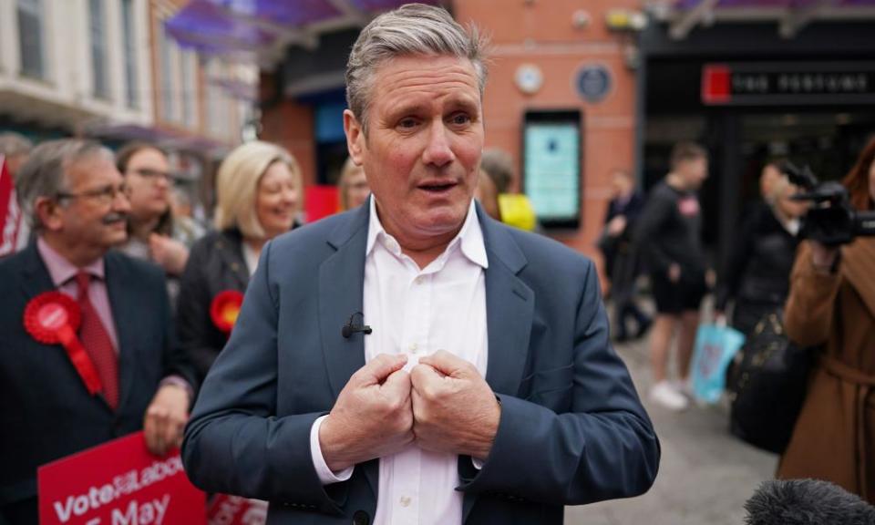 Keir Starmer speaks to people during local election campaigning in Workington, England.