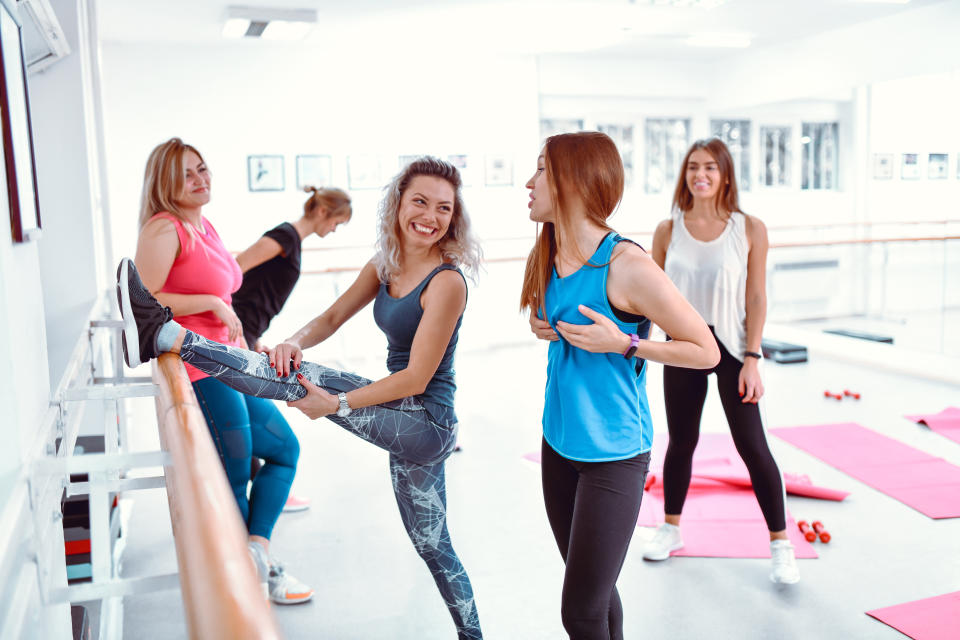 Females Discussing Cup Size In Gym While Stretching For Workout