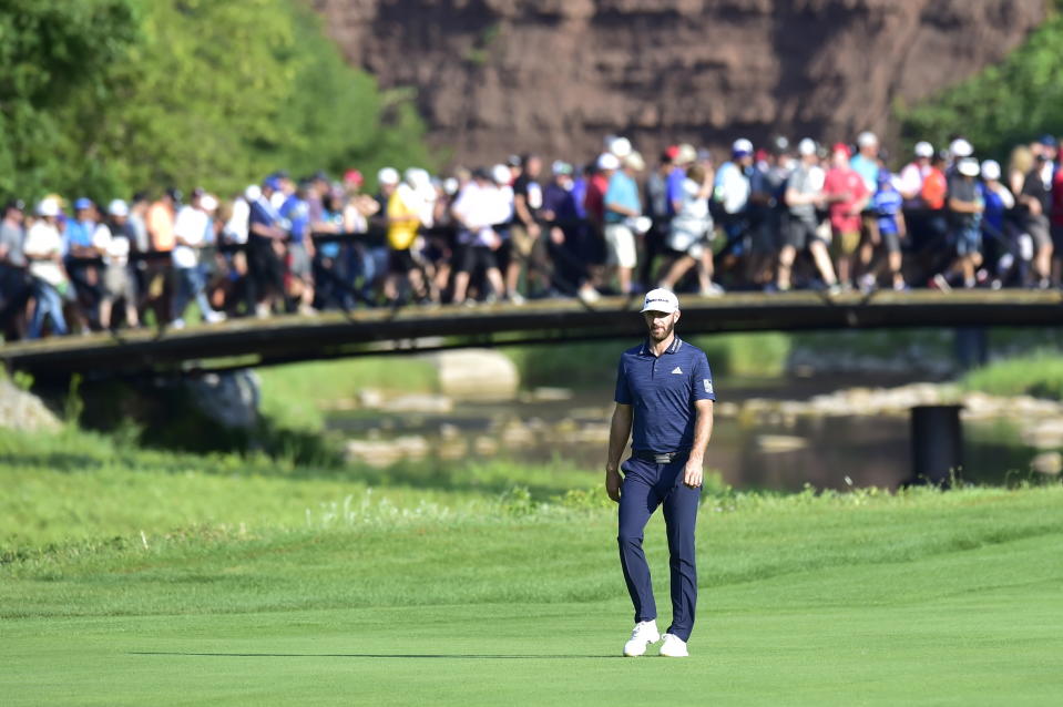 Dustin Johnson, of the United States, walks up the fairway of the 14th hole during the final round of the Canadian Open at the Glen Abbey Golf Club in Oakville, Ontario, Sunday, July 29, 2018. (Frank Gunn/The Canadian Press via AP)