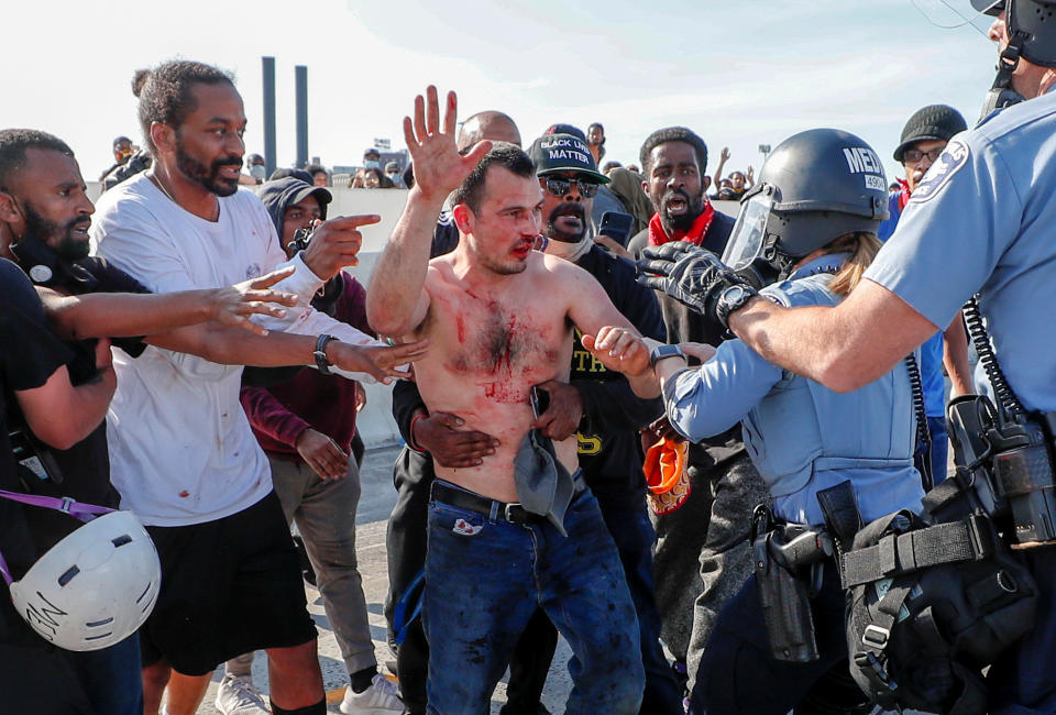 Pictured are George Floyd protesters handing over to the police the bloodied driver of the truck. Source: Reuters