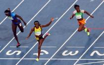 2016 Rio Olympics - Athletics - Final - Women's 100m Final - Olympic Stadium - Rio de Janeiro, Brazil - 13/08/2016. Elaine Thompson (JAM) of Jamaica crosses the finish line to win the gold medal. REUTERS/Fabrizio Bensch