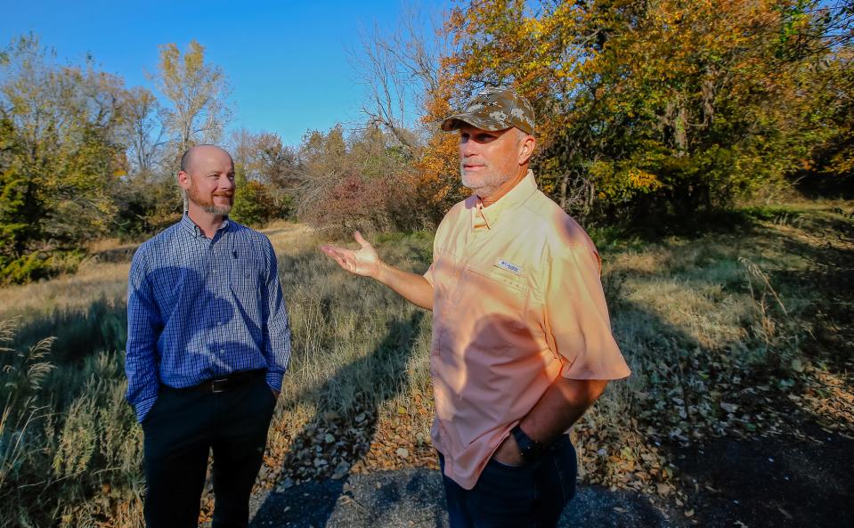 Ryan Ochsner, left, and Derek Smithee talk about conservation easement on park property south of Hafer Park in Edmond.