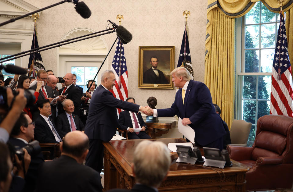 WASHINGTON, DC - OCTOBER 11:  U.S. President Donald Trump shakes hands with Chinese Vice Premier Liu He after announcing a &quot;phase one&quot; trade agreement with China in the Oval Office at the White House October 11, 2019 in Washington, DC.  China and the United States have slapped each other with hundreds of billions of dollars in tariffs since the current trade war began between the world’s two largest national economies in 2018. (Photo by Win McNamee/Getty Images)